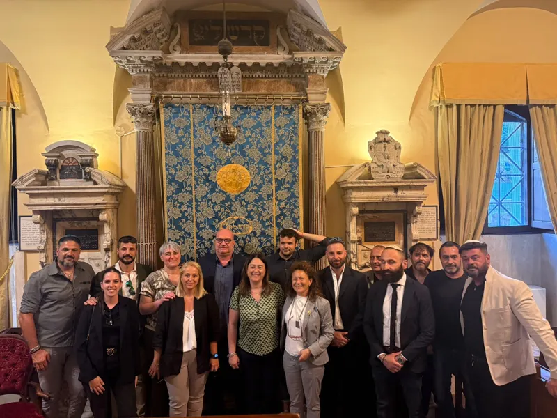 A group photo inside a historic synagogue