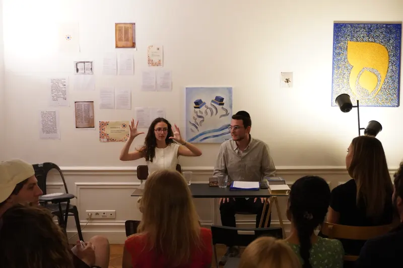 An Ambassador answering questions in a living room