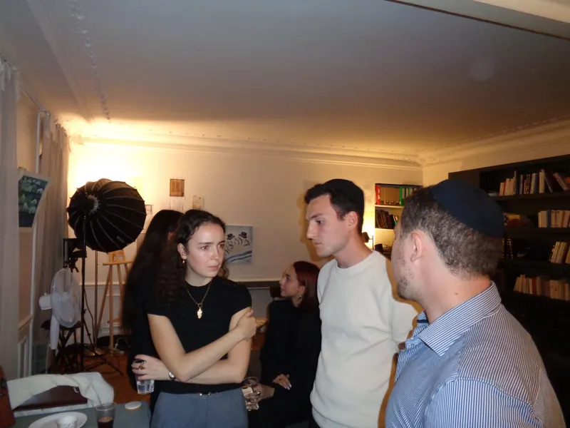 An Ambassador talking with a group in a living room