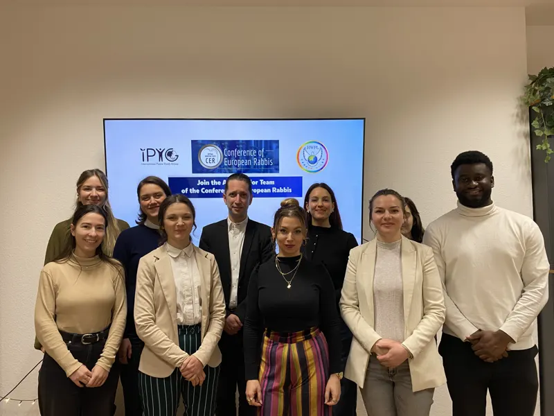 A young team with a rabbi after a meeting
